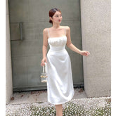 Silk midi dress with ruched bust and adjustable straps, featuring a sleek fitted silhouette